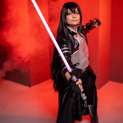 Dynamic Kirito cosplay from Sword Art Online: Gun Gale Online (GGO), showcasing the character in a powerful pose with his signature pink photon sword and striking black and white armor. Ideal for fans seeking epic Kirito or Sword Art Online cosplay inspiration