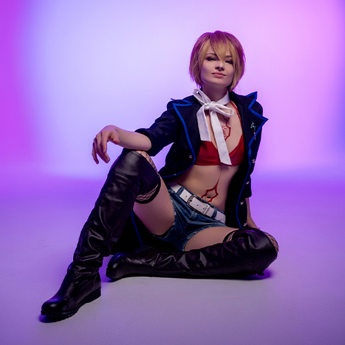 Dynamic Shura Kirigakure cosplay from Blue Exorcist, featuring her signature short blonde and red hair, red top, denim shorts, and a stylish jacket. Ideal for fans seeking detailed Blue Exorcist cosplay ideas or inspiration for portraying Shura