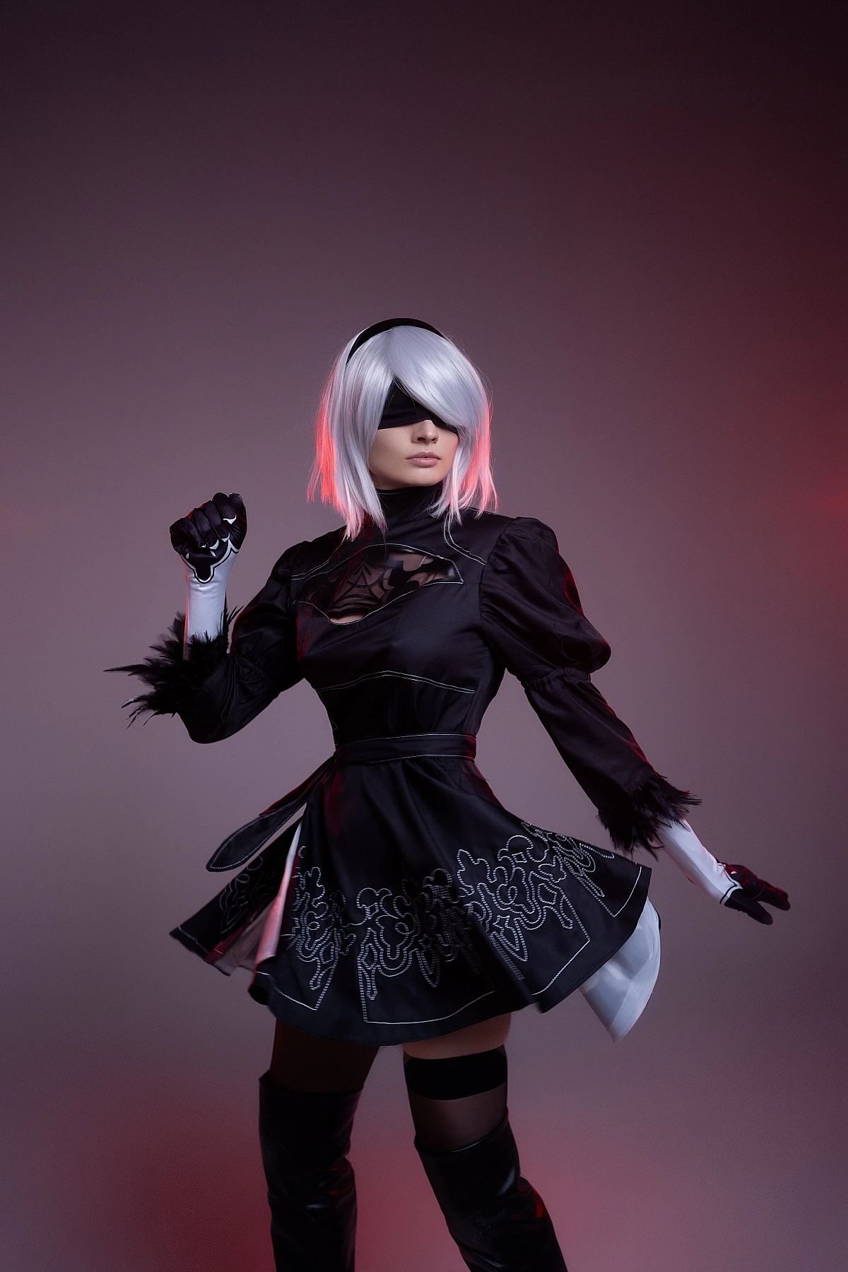 2B cosplay mid-turn with flowing skirt and red rim light, silver bob, black blindfold, NieR Automata motion photography