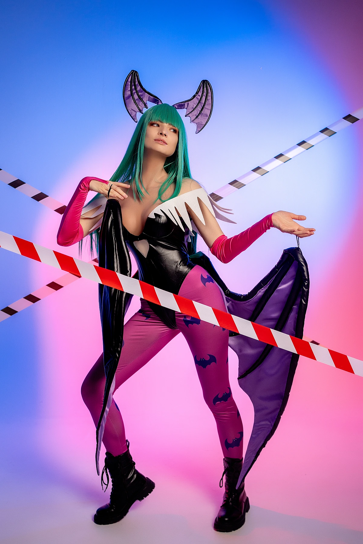 Full-body Morrigan Aensland cosplay balanced stance, neon blue-pink lighting, diagonal tape lines, succubus wings, green hair