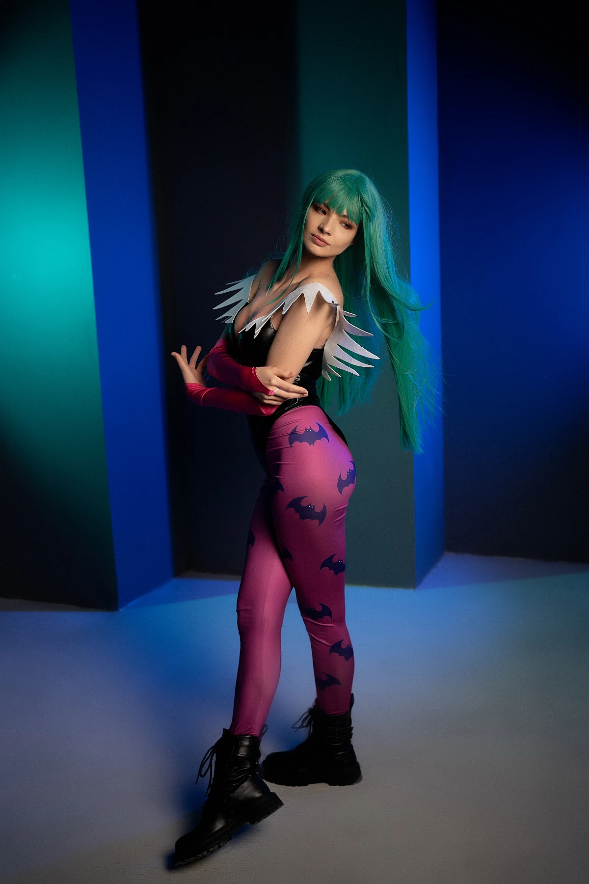 Morrigan Aensland cosplay side profile, flowing green hair, cool blue lighting, glossy bodysuit, succubus wings