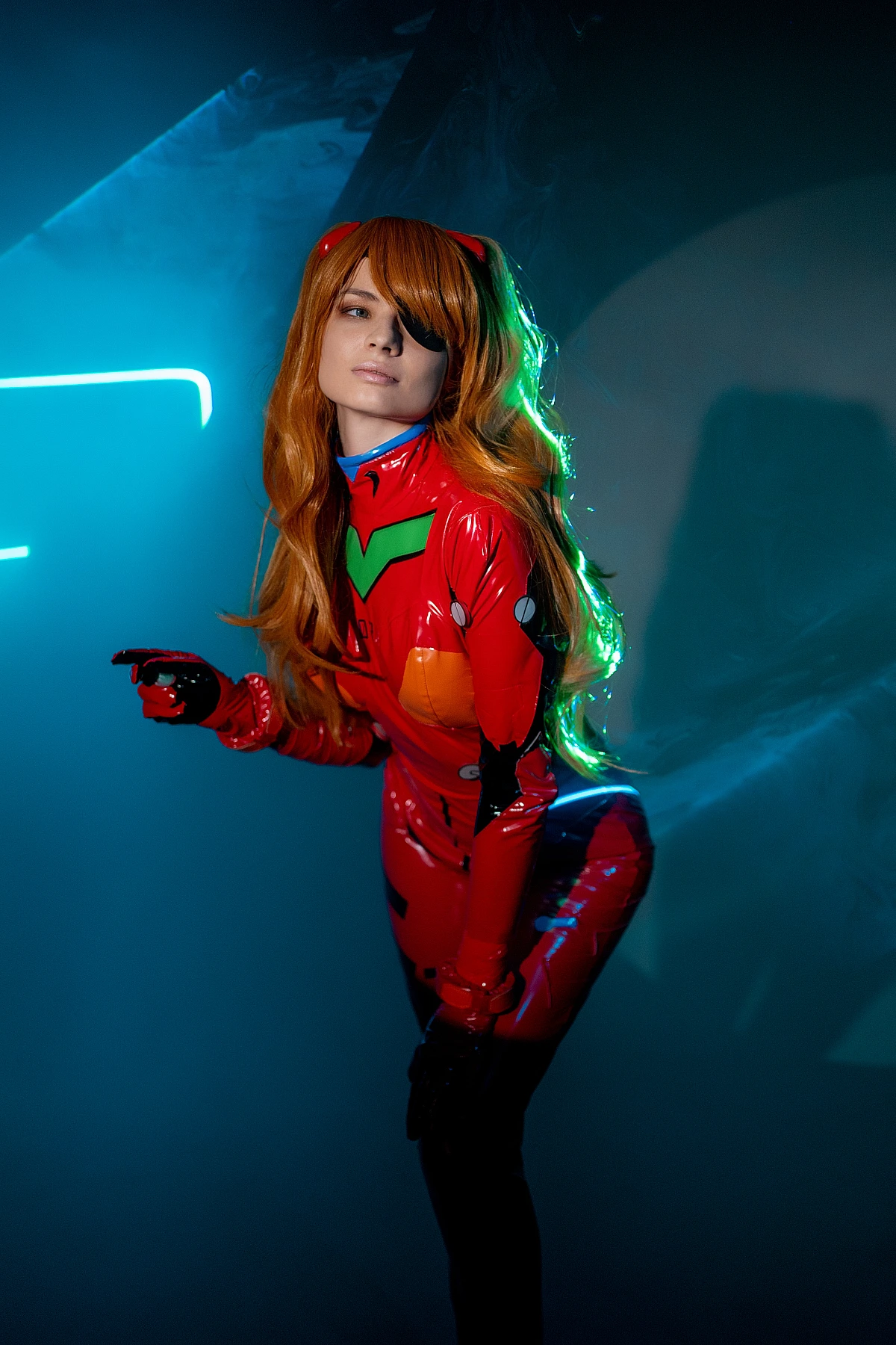 Moody side profile Asuka Langley plugsuit cosplay with subtle pointing gesture, soft neon edge light on red suit, flowing orange hair in dark studio
