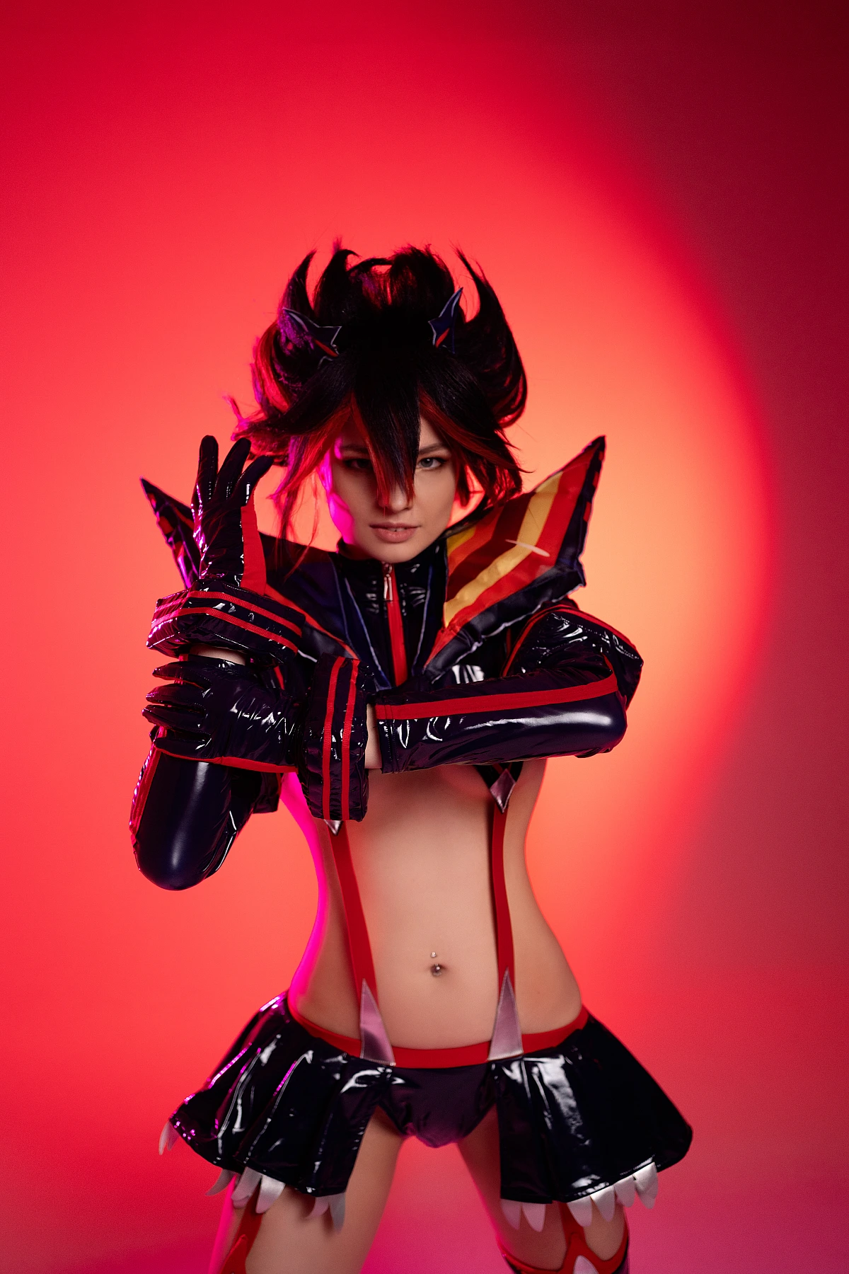 Ryuko Matoi cosplay dramatic portrait raised hands crimson red studio background glossy costume detail intense expression Kill la Kill