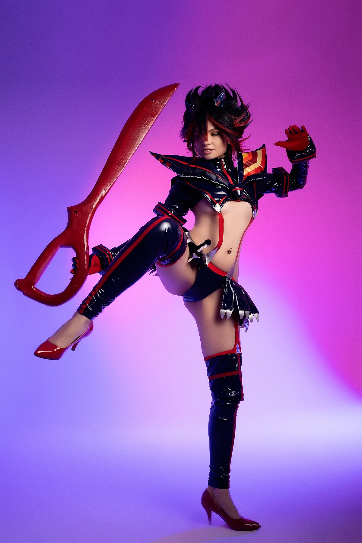 Ryuko Matoi cosplay performing high kick with extended scissor blade under neon purple pink studio lighting Kill la Kill