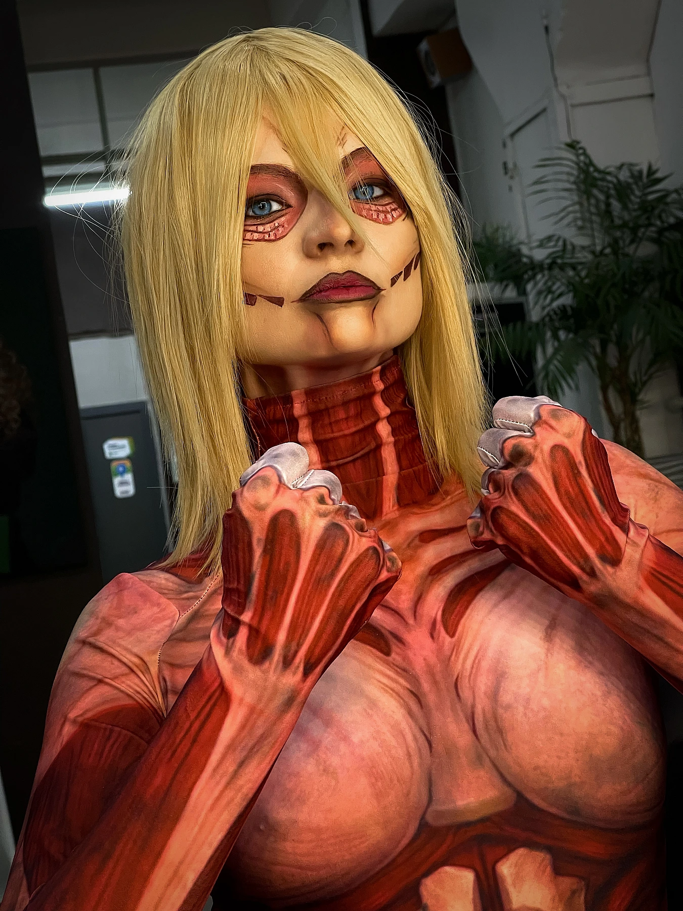 Female Titan cosplay intense portrait, Annie Leonhart, titan face makeup, clenched fists, AOT cosplay studio