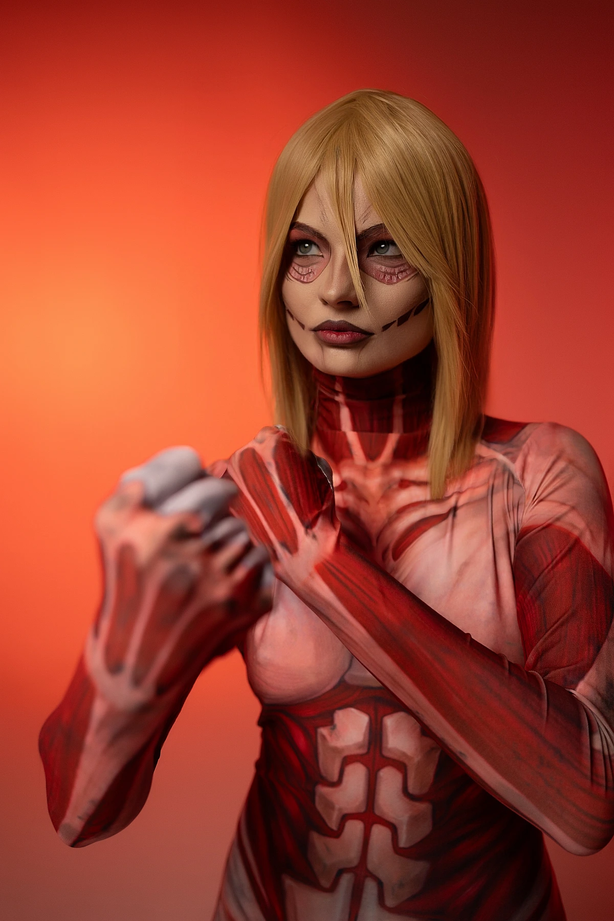 Female Titan cosplay portrait, red background, Annie Leonhart, clenched fist, Shingeki no Kyojin cosplay