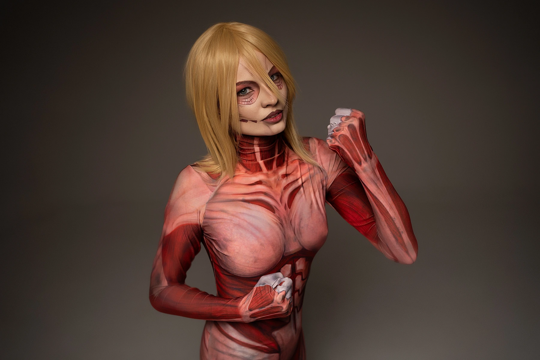 Female Titan cosplay half-body portrait, Annie Leonhart guard stance, clenched fists, titan makeup, AOT cosplay