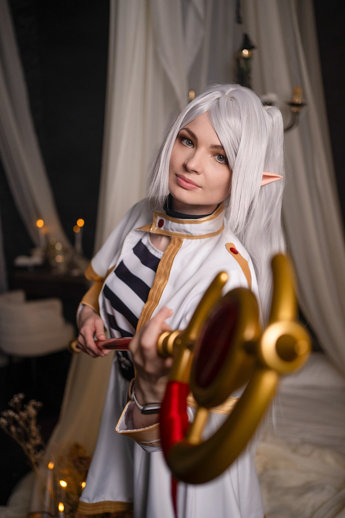 Frieren POV cosplay - first person view of elf mage pointing staff at viewer from Sousou no Frieren