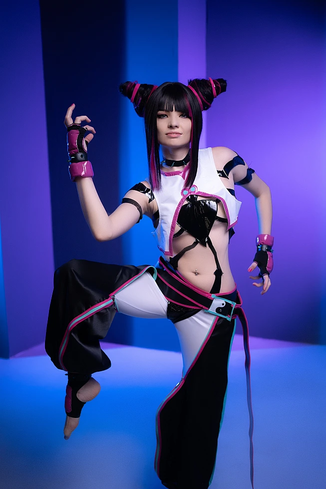 Juri Han cosplayer balancing on one leg with raised knee, cool blue-violet neon lighting, glossy strap costume, horn buns, Street Fighter