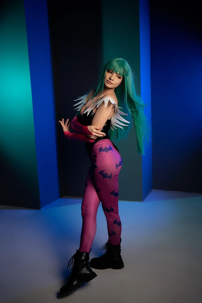 Morrigan Aensland cosplay side profile, flowing green hair, cool blue lighting, glossy bodysuit, succubus wings