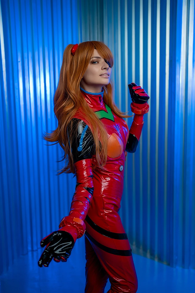 Elegant side profile Asuka Langley cosplay reaching with extended red glove, glossy plugsuit with cool blue lighting reflections against metallic industrial wall