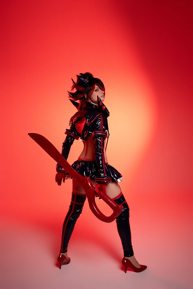 Ryuko Matoi cosplay rear view with red backlight silhouette scissor blade over shoulder glossy Senketsu outfit Kill la Kill