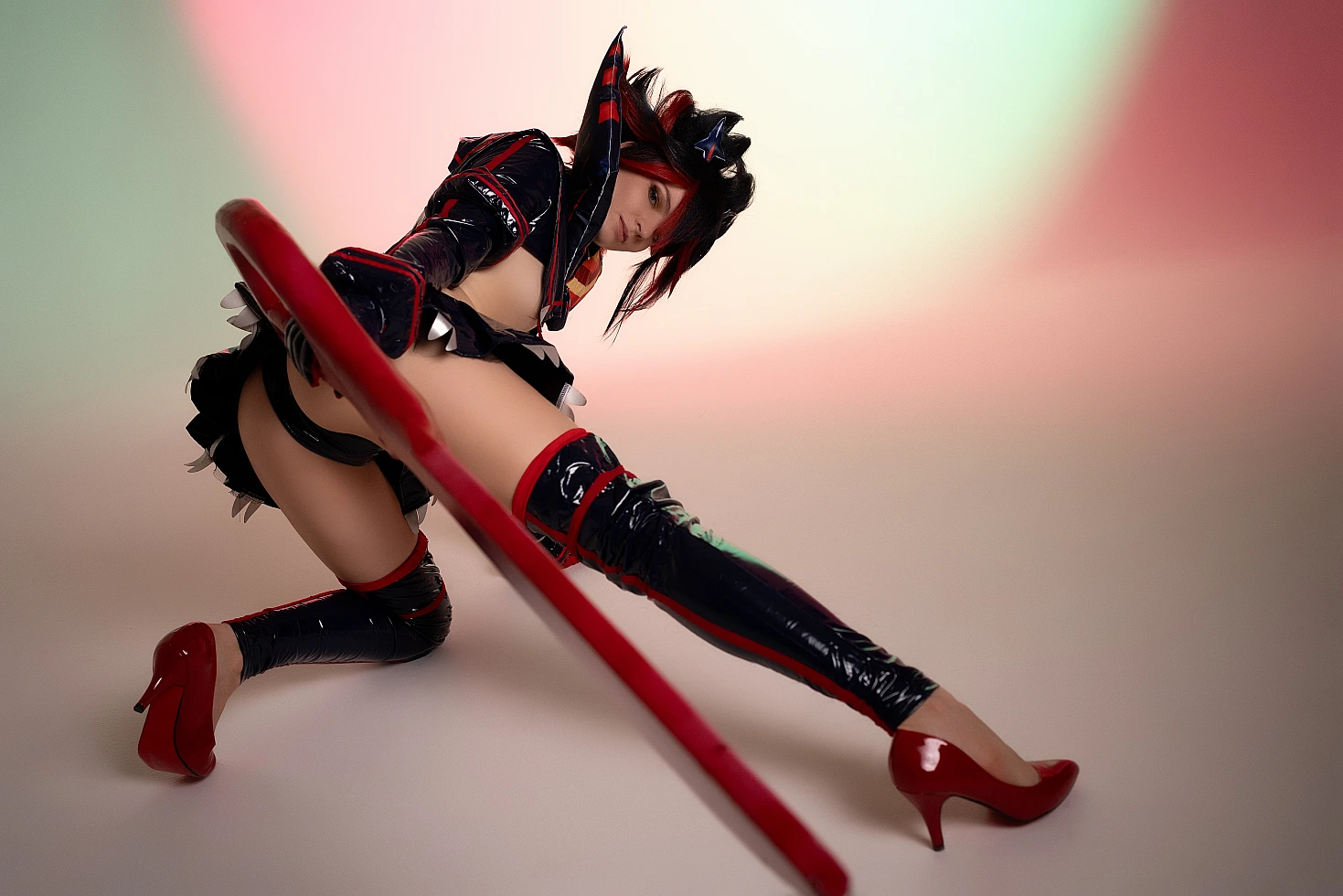 Ryuko Matoi cosplay low angle perspective extended leg scissor blade foreground studio gradient Kill la Kill power pose
