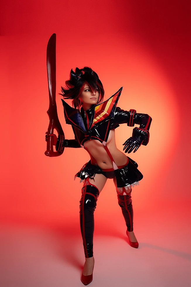 Ryuko Matoi cosplay combat ready pose raised scissor blade deep red studio lighting high contrast silhouette Kill la Kill battle