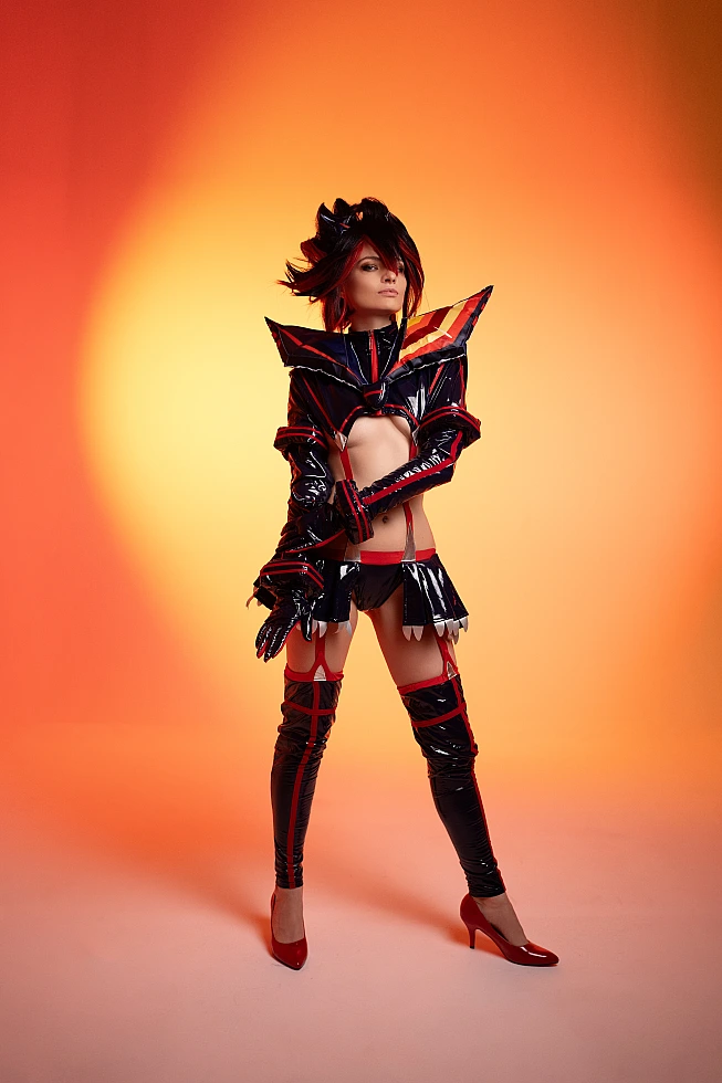 Ryuko Matoi cosplay front stance centered pose orange studio background wetlook glossy Senketsu costume confident posture Kill la Kill