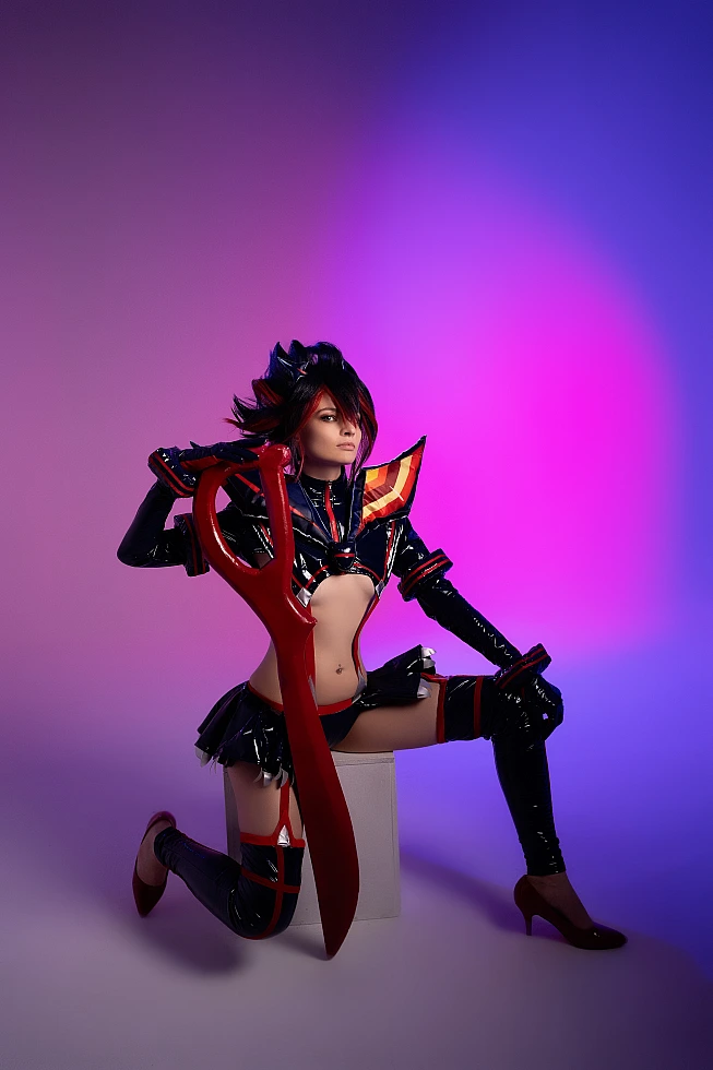 Ryuko Matoi cosplay kneeling on studio block upright scissor blade violet magenta gradient background Senketsu Kill la Kill contemplative