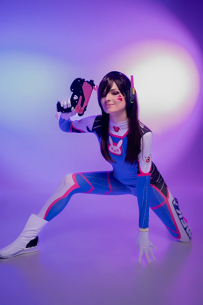 D.Va Overwatch cosplay low action stance blaster raised purple neon studio lighting dynamic gaming pose