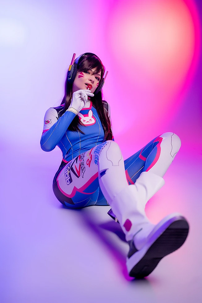 D.Va Overwatch cosplay reclining low angle perspective pink violet neon lighting artistic studio photography
