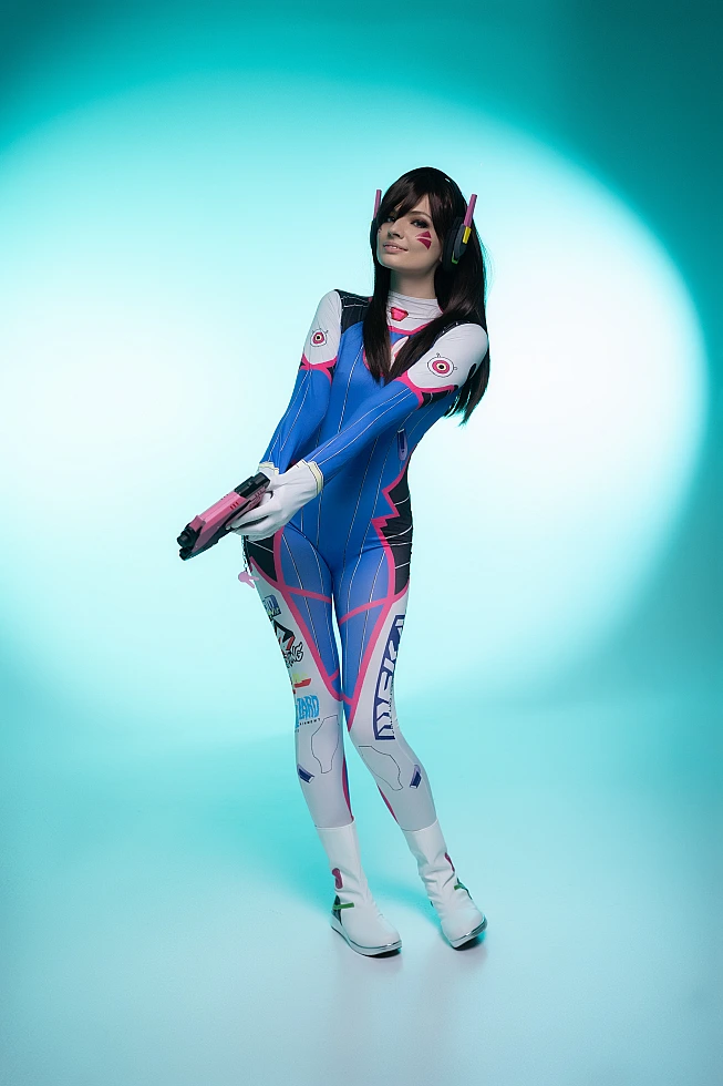 D.Va Overwatch cosplay full body blaster cyan halo lighting composed stance minimalist studio professional finale