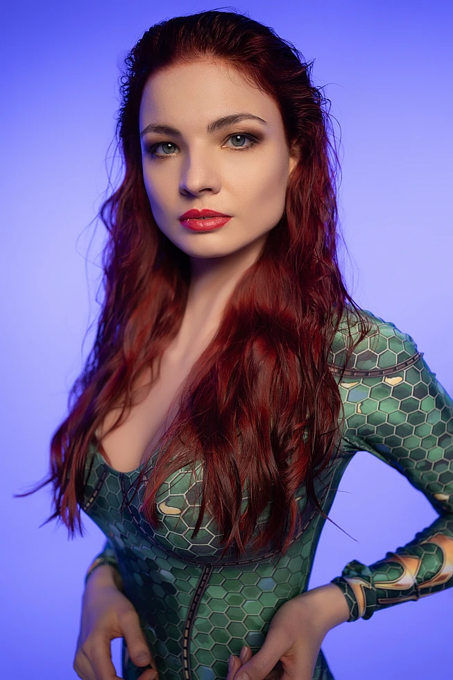 Cinematic close-up Mera cosplay portrait with intense eyes and emerald scale bodysuit detail
