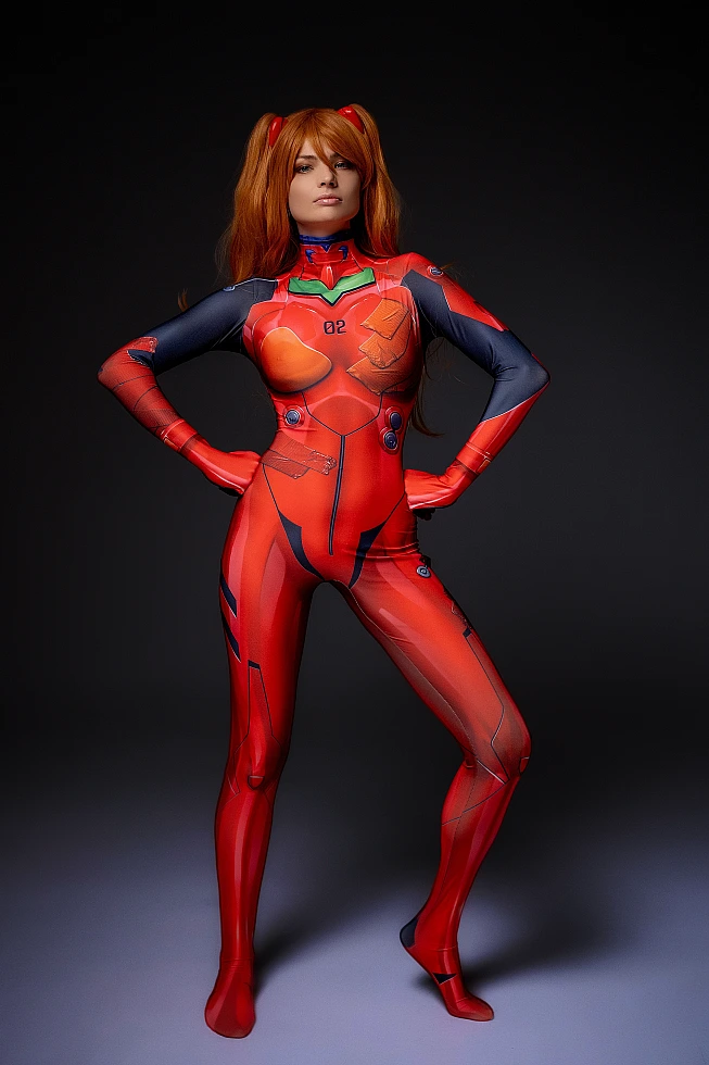 Full body Asuka Langley cosplay in red plugsuit with hands on hips against dark background