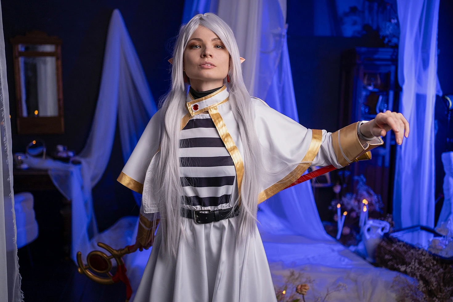 Frieren spellcasting cosplay - elf mage casting magic spell with blue light from Sousou no Frieren