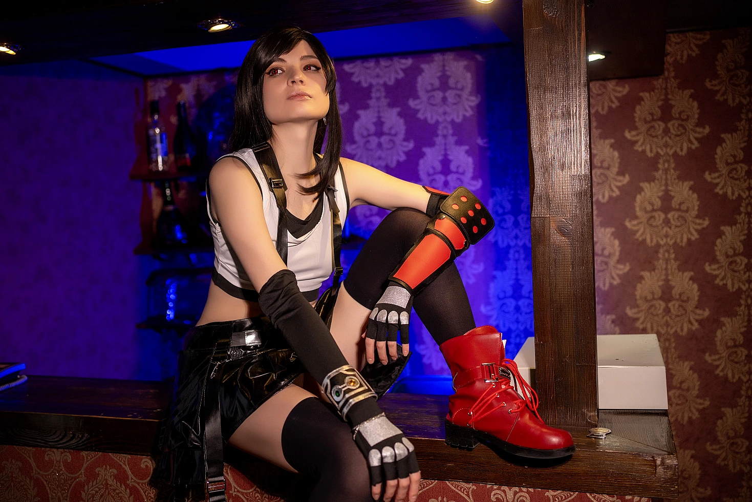 Tifa Lockhart cosplay elegant raised knee bar pose, red boots highlighted, FF7 black skirt costume, cinematic blue and amber contrast lighting