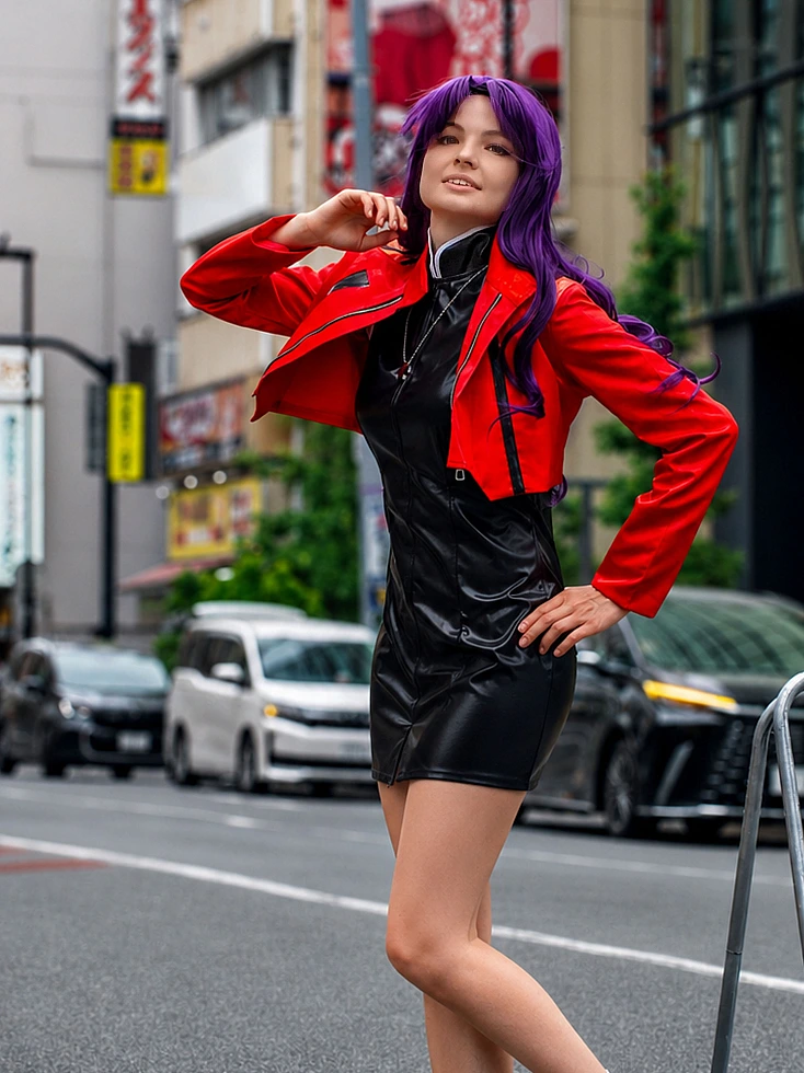 Misato Katsuragi cosplay portrait in a red jacket and black dress with purple hair on a Tokyo street
